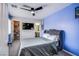 Bedroom featuring blue accent wall, carpet, ceiling fan, and closet with shelving for organized storage at 6630 Virtuoso Ct, Las Vegas, NV 89139