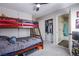 Bedroom with bunk beds, carpet, ceiling fan, closet, and ensuite bathroom for added convenience at 6630 Virtuoso Ct, Las Vegas, NV 89139