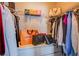 This walk-in closet features wire shelving, hanging rods and a built-in cabinet with luxury bags at 6630 Virtuoso Ct, Las Vegas, NV 89139