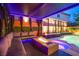 Relaxing outdoor fire pit area with comfortable seating, ambient lighting, and a view of the pool and spa at 6630 Virtuoso Ct, Las Vegas, NV 89139