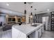 Open-concept kitchen features a large island, stainless steel appliances, and grey cabinets at 6630 Virtuoso Ct, Las Vegas, NV 89139