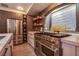 Modern kitchen featuring stainless steel appliances, sleek countertops, and decorative shelving at 6630 Virtuoso Ct, Las Vegas, NV 89139
