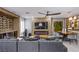 Open living area with a fireplace, large television, and a built-in wine storage and display area at 6630 Virtuoso Ct, Las Vegas, NV 89139