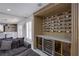 Living room area featuring custom wine storage, wet bar, and comfortable seating at 6630 Virtuoso Ct, Las Vegas, NV 89139
