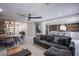 Open-concept living space with modern furniture, stylish decor, and a view of the kitchen at 6630 Virtuoso Ct, Las Vegas, NV 89139