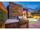 Inviting outdoor kitchen area with stone accents, a built-in grill, and a view of the sparkling pool at 6630 Virtuoso Ct, Las Vegas, NV 89139