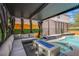 Charming outdoor lounge with a fire pit, comfortable seating, and spa in a backyard setting at 6630 Virtuoso Ct, Las Vegas, NV 89139