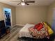Comfortable bedroom featuring wood-look floors, a ceiling fan, and access to a closet for ample storage at 6800 E Lake Mead Blvd # 1126, Las Vegas, NV 89156