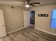 Inviting bedroom with sleek wood-look flooring, ceiling fan and a view of the living area at 6800 E Lake Mead Blvd # 1126, Las Vegas, NV 89156