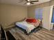 Cozy bedroom with ceiling fan and wood-look flooring, ready for relaxation and personalization at 6800 E Lake Mead Blvd # 1126, Las Vegas, NV 89156