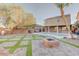 Spacious backyard featuring a fire pit, pool, and manicured landscaping, perfect for outdoor gatherings and relaxation at 6826 Dovecote Ave, North Las Vegas, NV 89084