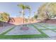 Backyard featuring a fire pit and manicured landscaping, perfect for outdoor gatherings and relaxation at 6826 Dovecote Ave, North Las Vegas, NV 89084