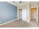 This bedroom has soft blue walls, a sliding closet door, and grey carpeting at 6826 Dovecote Ave, North Las Vegas, NV 89084