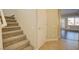 Entryway featuring tile floors, staircase, and a glimpse of the adjacent living spaces at 6826 Dovecote Ave, North Las Vegas, NV 89084