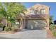Charming two-story home featuring a well-manicured front yard and a neutral stucco exterior at 6826 Dovecote Ave, North Las Vegas, NV 89084