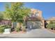Charming two-story home featuring a well-manicured front yard and a neutral stucco exterior at 6826 Dovecote Ave, North Las Vegas, NV 89084