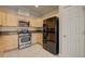 The kitchen features stainless steel appliances and light wooden cabinetry at 6826 Dovecote Ave, North Las Vegas, NV 89084