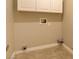 A compact laundry room with clean white walls and tile flooring at 6826 Dovecote Ave, North Las Vegas, NV 89084