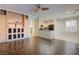 Living room features wood floors, built-in storage, and an open layout to the kitchen at 6826 Dovecote Ave, North Las Vegas, NV 89084
