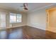 Living room features wood floors, neutral paint, ceiling fan, and natural light at 6826 Dovecote Ave, North Las Vegas, NV 89084