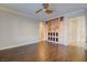 Spacious living room featuring hardwood floors, a ceiling fan, and built-in shelving at 6826 Dovecote Ave, North Las Vegas, NV 89084