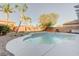 Sparkling pool with baja step and lush landscaping, creating a perfect backyard oasis for relaxation and enjoyment at 6826 Dovecote Ave, North Las Vegas, NV 89084