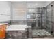 Modern bathroom featuring a glass shower, soaking tub, and updated fixtures at 7252 Royal Melbourne Dr, Las Vegas, NV 89131