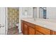 Bathroom with wood-look tile, stylish vanity, and shower with decorative curtain at 7252 Royal Melbourne Dr, Las Vegas, NV 89131