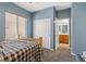 Bedroom showing a window, closet doors, and an open doorway to the bathroom at 7252 Royal Melbourne Dr, Las Vegas, NV 89131