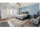 Bright bedroom featuring neutral walls, carpeted floor, a large bed, and modern furnishings at 7252 Royal Melbourne Dr, Las Vegas, NV 89131