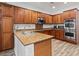 Bright, open kitchen with a large island, granite countertops, stainless appliances and wood finish cabinets at 7252 Royal Melbourne Dr, Las Vegas, NV 89131