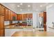 Well-lit kitchen featuring granite countertops, stainless steel appliances and wood finish cabinets at 7252 Royal Melbourne Dr, Las Vegas, NV 89131