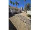 The backyard features desert landscaping with rocks and a patio area, perfect for relaxing at 79 Magical Mystery Ln, Henderson, NV 89074