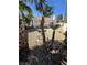 The backyard showcases desert-style landscaping with rocks, grass and palms, enhancing privacy at 79 Magical Mystery Ln, Henderson, NV 89074