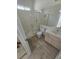 Bathroom with wood-look floors, a glass enclosed shower, toilet, sink and vanity with a large mirror at 79 Magical Mystery Ln, Henderson, NV 89074