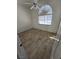 A bright bedroom with a large window, ceiling fan, and wood-look tiled floors at 79 Magical Mystery Ln, Henderson, NV 89074