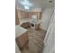 Well-lit kitchen features wood-look floors, wooden cabinetry, white countertops, and stainless steel appliances at 79 Magical Mystery Ln, Henderson, NV 89074