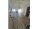 Open-concept living room with wood-look tiled floors leading to the backyard at 79 Magical Mystery Ln, Henderson, NV 89074