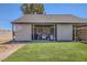 View of the backyard featuring a manicured lawn and well-appointed outdoor kitchen at 80 E Texas Ave, Henderson, NV 89015