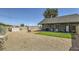 Large backyard with gravel landscaping, fire pit, outdoor kitchen, and storage shed at 80 E Texas Ave, Henderson, NV 89015