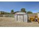 View of the backyard featuring a storage shed, a table, and a landscaped block wall at 80 E Texas Ave, Henderson, NV 89015