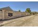 Spacious lot showcasing the backyard wall and gate, offering privacy and potential at 80 E Texas Ave, Henderson, NV 89015