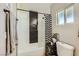 This bathroom features modern fixtures, a black and white accent wall, and a tiled shower at 80 E Texas Ave, Henderson, NV 89015