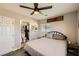 Cozy bedroom featuring a ceiling fan, comfortable bed, and an ensuite bathroom for added convenience at 80 E Texas Ave, Henderson, NV 89015