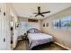 Comfortable bedroom with natural light, ceiling fan, and a view to a tiled shower at 80 E Texas Ave, Henderson, NV 89015