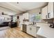 Bright kitchen with white cabinets, quartz countertops, and stainless steel dishwasher at 80 E Texas Ave, Henderson, NV 89015