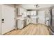 Bright kitchen featuring white cabinets, stainless steel appliances, and wood-look flooring at 80 E Texas Ave, Henderson, NV 89015