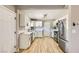 Well-lit kitchen with stainless steel refrigerator and a view into the main living area at 80 E Texas Ave, Henderson, NV 89015