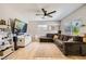 Cozy living room with a large sectional sofa, wood floors, and a wall-mounted TV at 80 E Texas Ave, Henderson, NV 89015