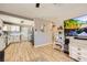 Open-concept living room with hardwood floors seamlessly connecting to kitchen at 80 E Texas Ave, Henderson, NV 89015